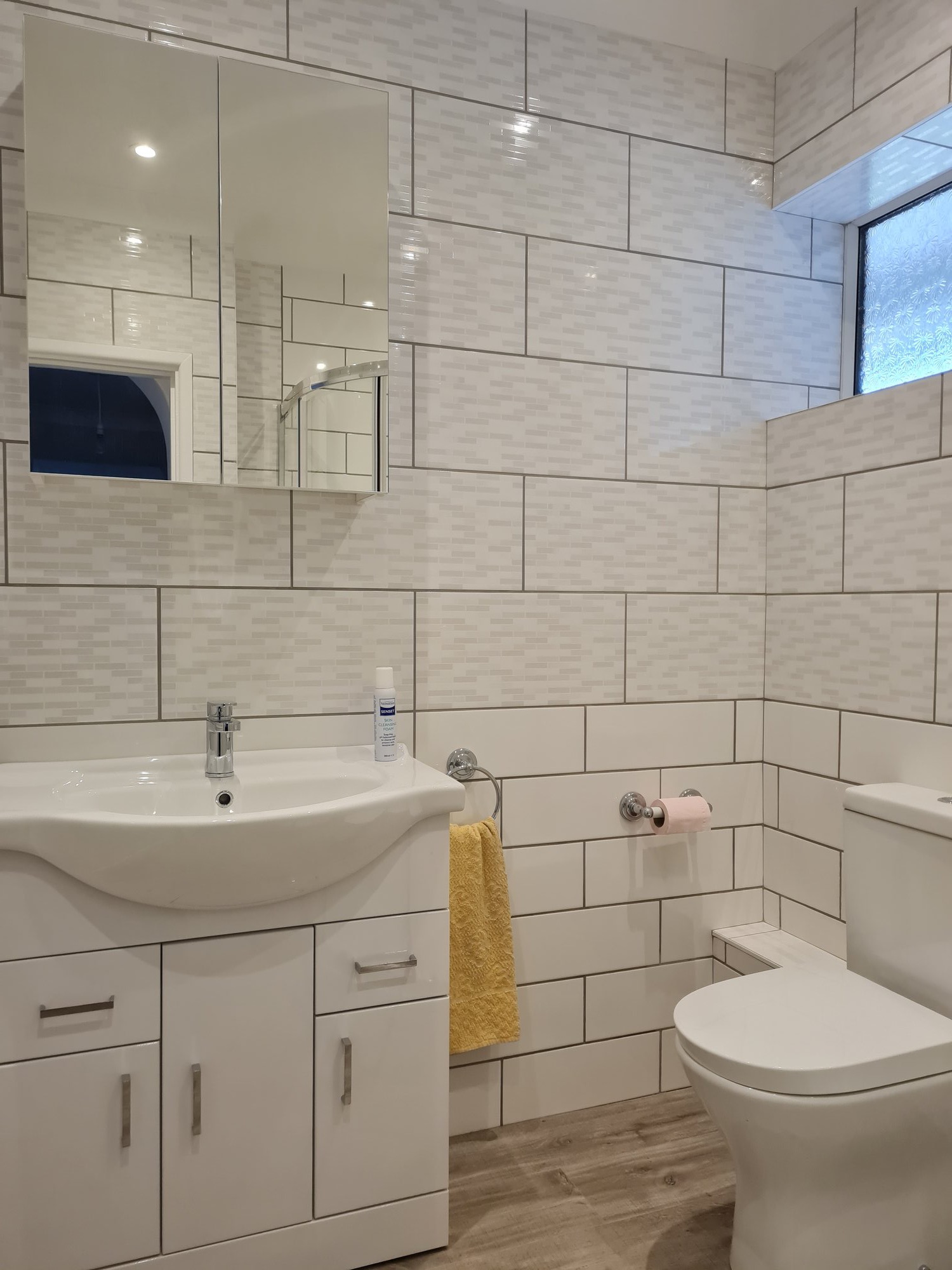 Complete bathroom with vanity and tiling
