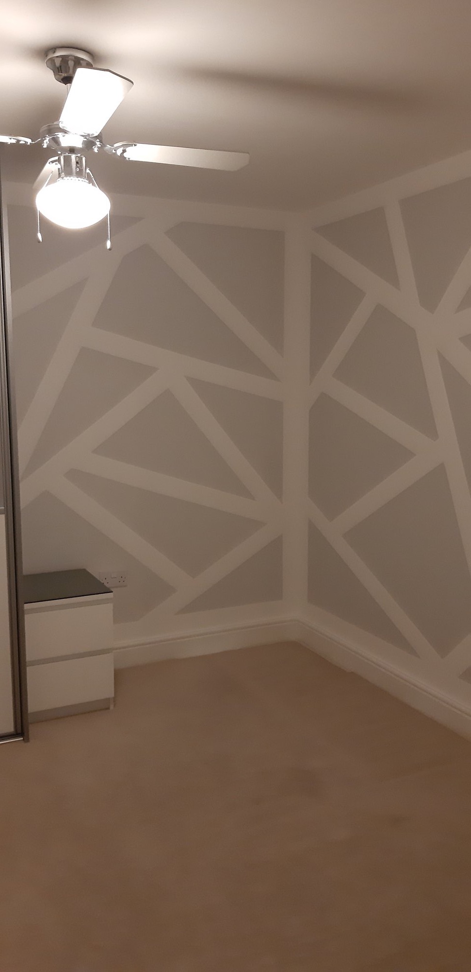 Geometric feature wall with fitted wardrobes